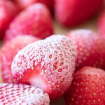 frozen strawberries on a parchment lined baking sheet