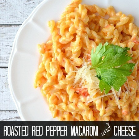 roasted red pepper macaroni and cheese on a plate with parsley and parmesan garnish with text title written on bottom for pinterest
