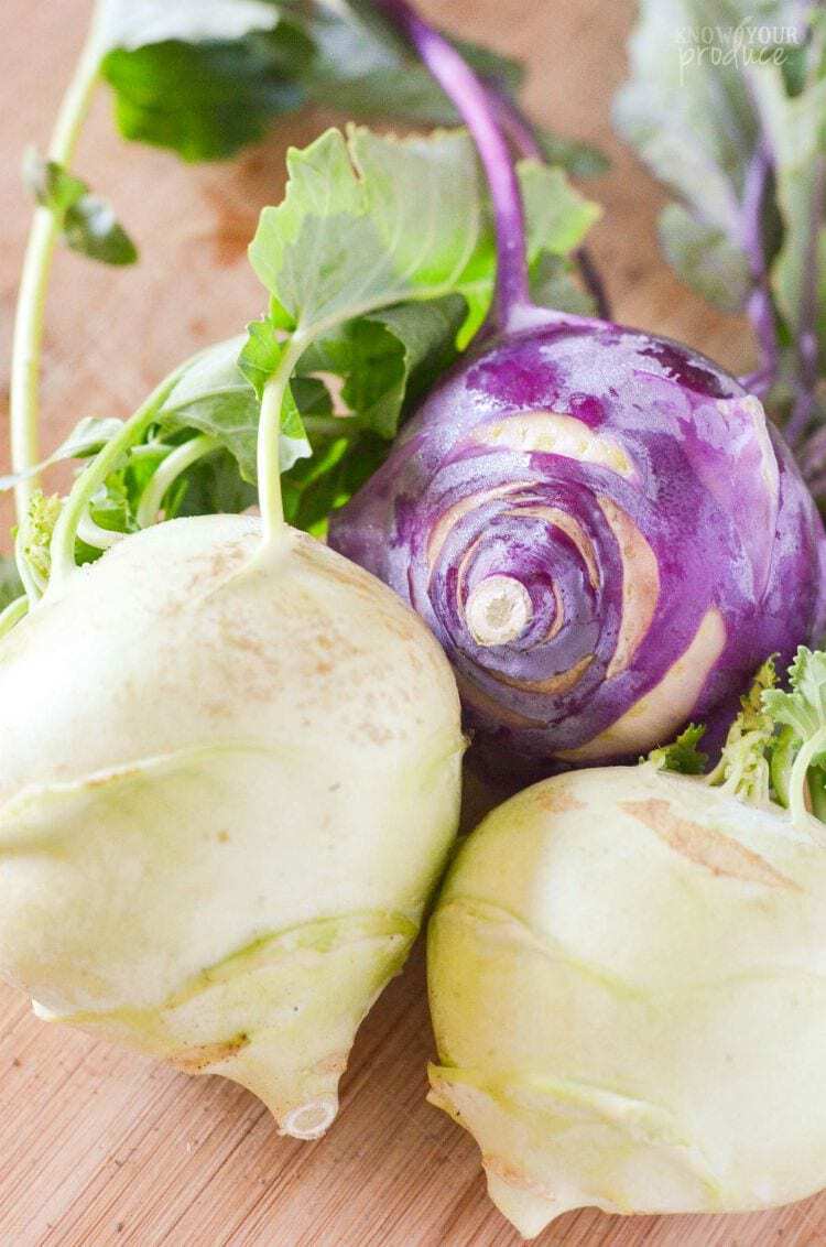 purple and green kohlrabi with leaves attached