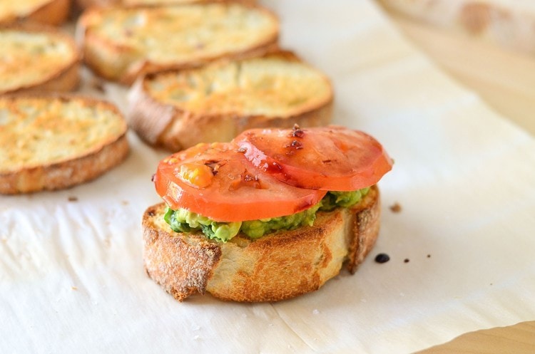 toast with kale guacamole, sliced tomatoes, and drizzled balsamic vinegar 