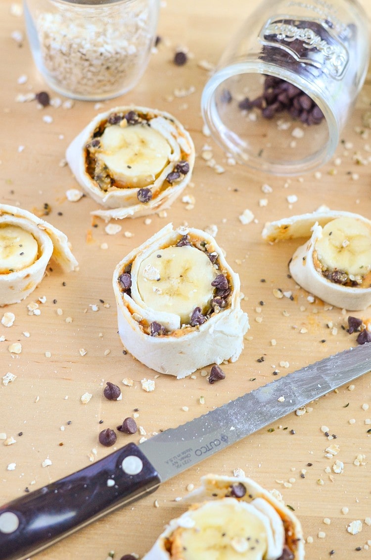 I love the combo of peanut butter oatmeal for breakfast, but my toddler really enjoys when we make Peanut Butter Oatmeal Banana Roll-ups with Chocolate Chips! These banana roll-ups are filled with healthy food super foods like natural peanut butter, chia seeds, hemp hearts and semi-sweet chocolate chips.