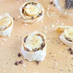 I love the combo of peanut butter oatmeal for breakfast, but my toddler really enjoys when we make Peanut Butter Oatmeal Banana Roll-ups with Chocolate Chips! These banana roll-ups are filled with healthy food super foods like natural peanut butter, chia seeds, hemp hearts and semi-sweet chocolate chips.