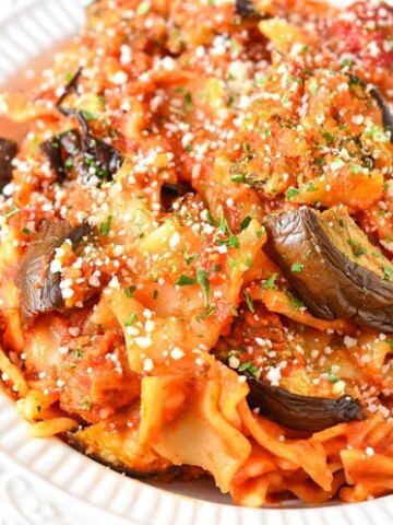 Eggplant Parmesan Pasta using our Easy Eggplant Parmesan Recipe using a thick and hearty sauce, cheeses and herbs. This is a simple dinner recipe that you can make in less than 30 minutes! 