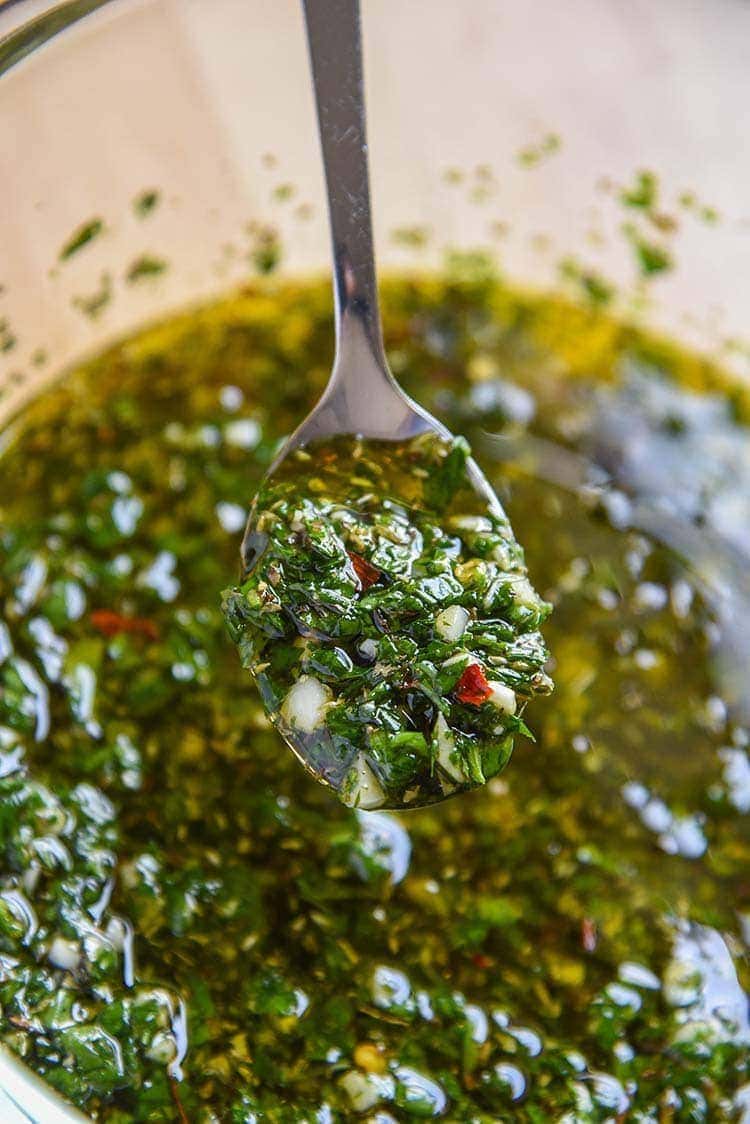 Chimichurri Sauce in a bowl with a spoon.