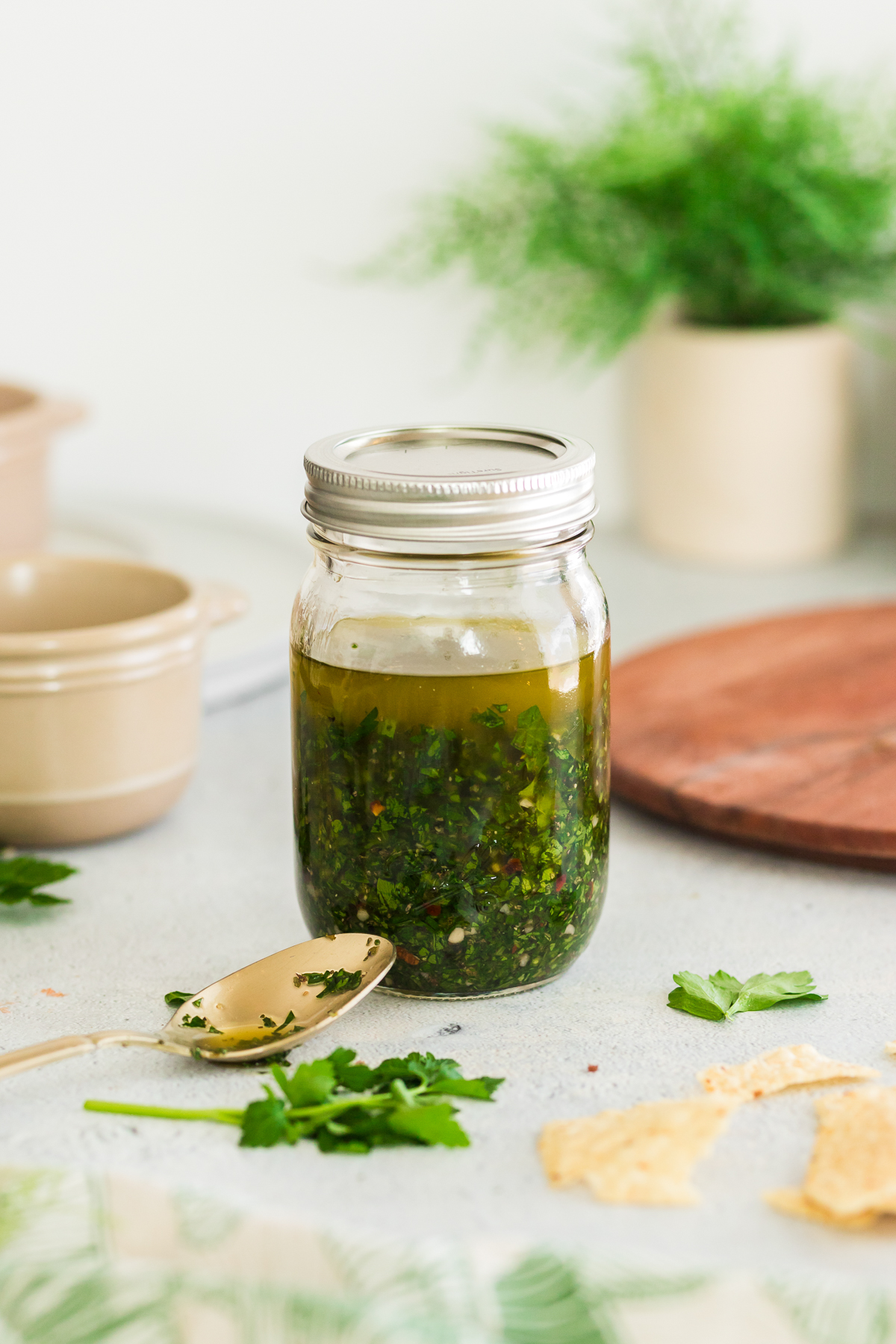 homemade chimichurri sauce in a glass mason jar.