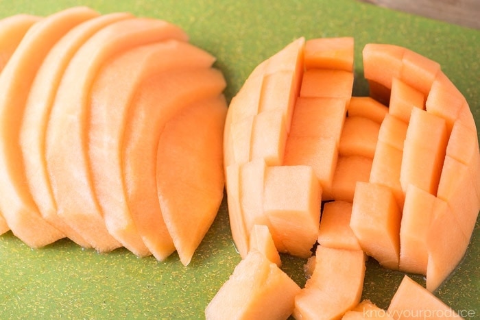 how to cut a cantaloupe cubes and wedges on a green cutting board