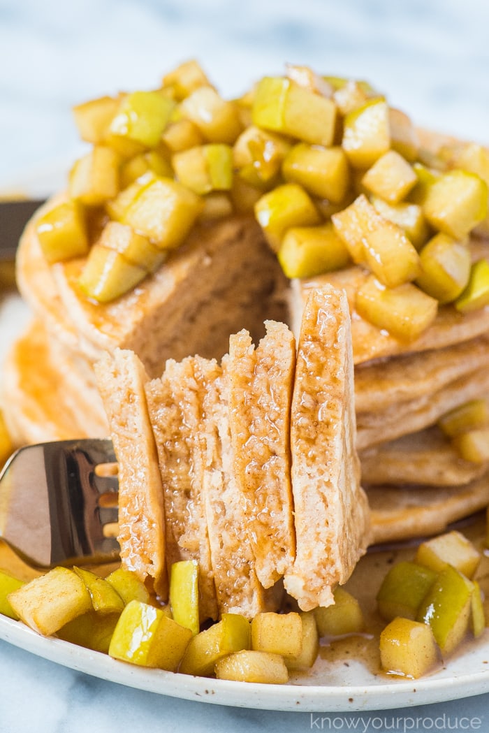 apple cinnamon pancakes cut with a fork