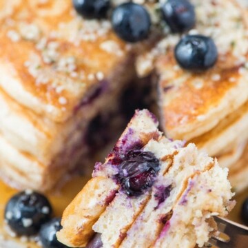 blueberry pancakes on fork cut with fresh blueberryes