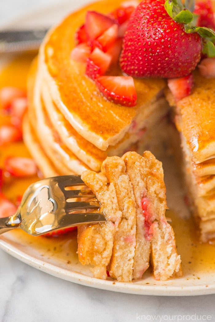 strawberry pancakes cut with a fork