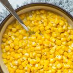 butter corn in a bowl with a spoon