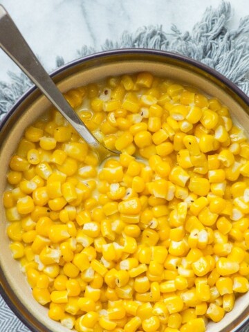 butter corn in a bowl with a spoon