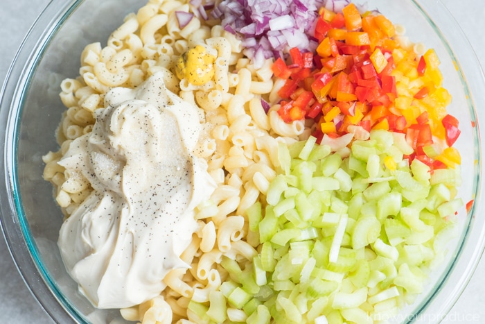 easy macaroni salad ingredients in a bowl with peppers celery and onion