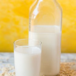 oat milk in a glass and in a pitcher