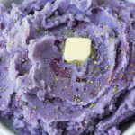 purple mashed potatoes in a bowl with a tab of butter