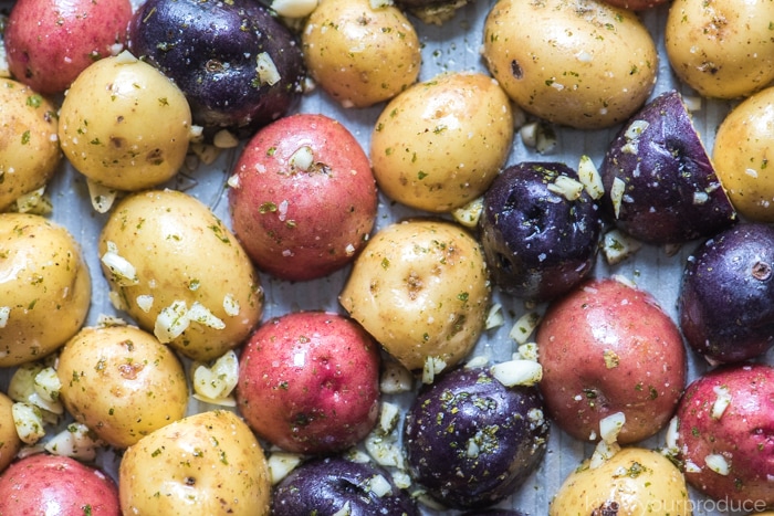 baby potatoes with seasonings on a sheet pan for roasting