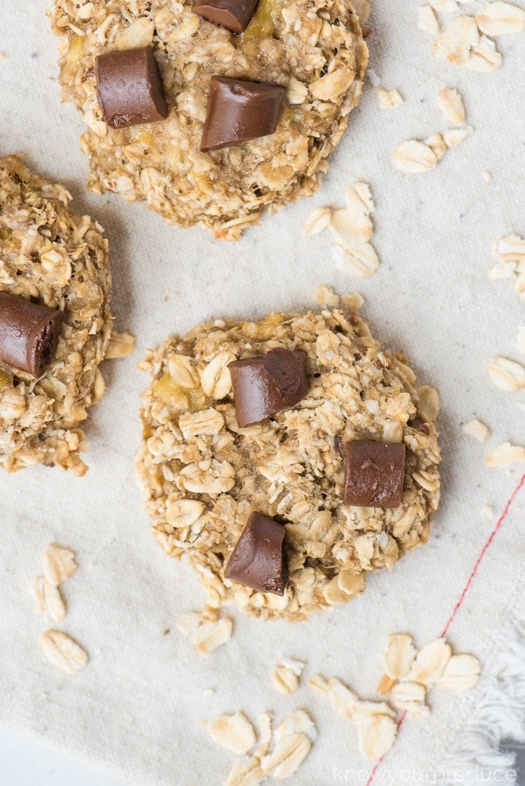 banana oatmeal cookies with scattered rolled oats on a cloth napkin