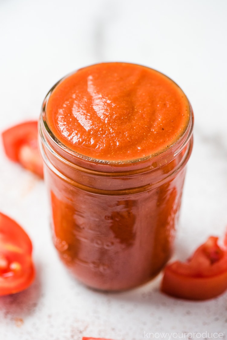 homemade taco sauce recipe in ball mason jar with sliced tomatoes on the sides