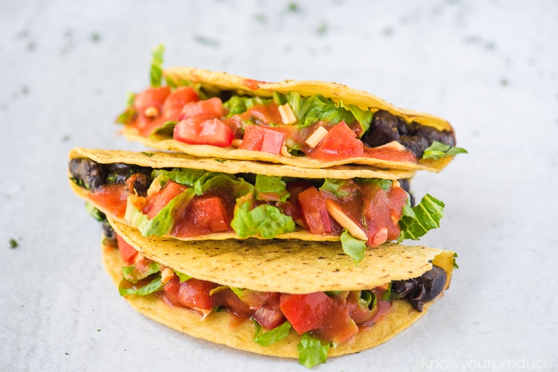 siete grain free taco shells stuffed with black beans lettuce pico de gallo and vegan cheddar cheese