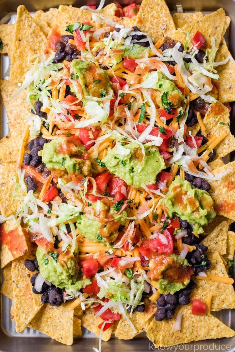 close up of nachos on a baking sheet