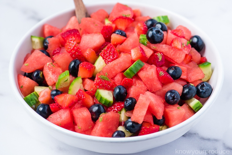 fresh watermelon salad with blueberries cucumber and mint in a white low bowl