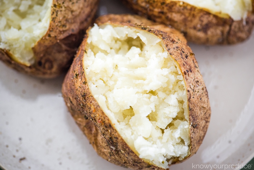 fluffy baked potato on a plate cut open