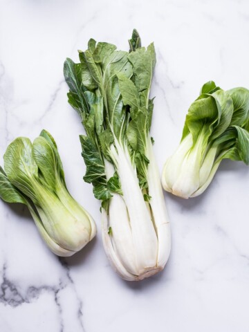 large bok choy and baby bok choy on a marble board