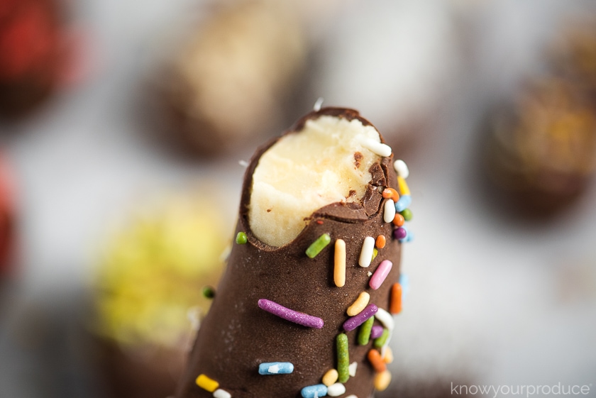 chocolate covered banana with sprinkles with a bite taken out