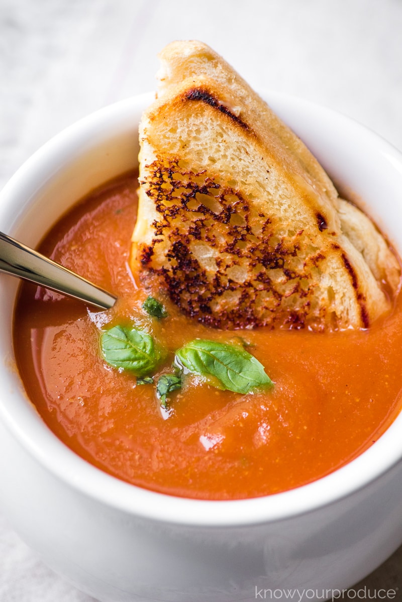 fresh tomato soup in a bowl with grilled cheese