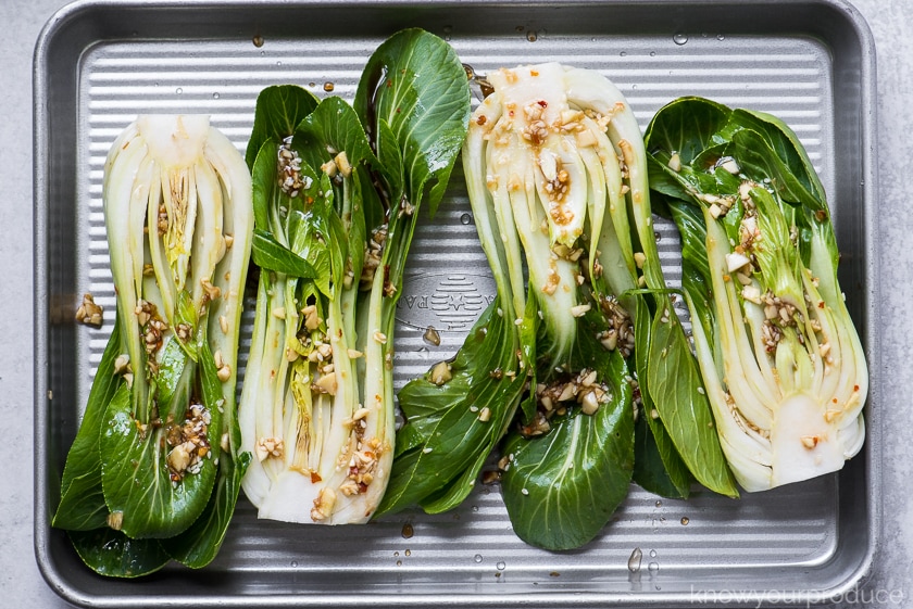 bok choy ready to roast on a baking sheet