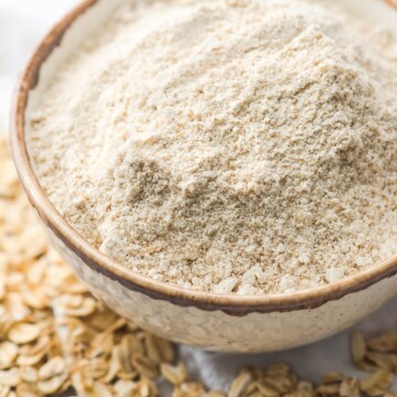 oat flour in a bowl with oats on the table