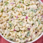 vegan tuna pasta salad in a white low bowl with spoon and pink cloth