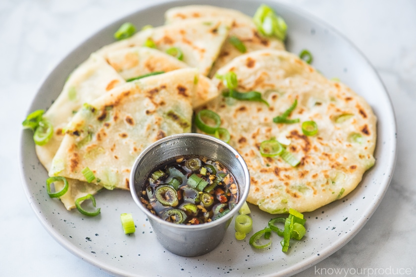 scallion pancakes on a plate with chinese dipping sauce