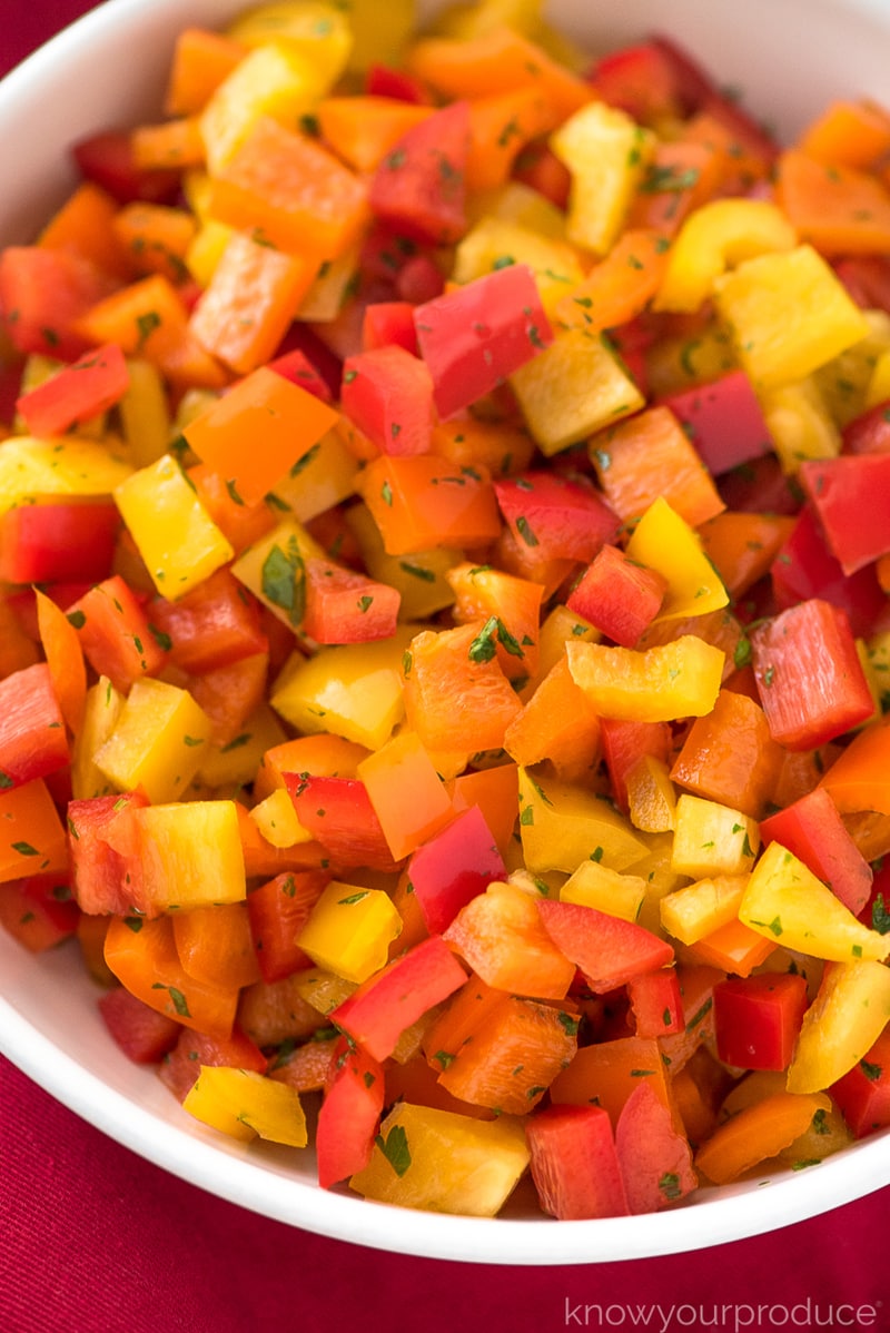 bell pepper salad in a white bowl with red napkin underneath 