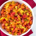 chopped bell pepper salad in a white bowl on a red napkin