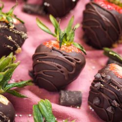 chocolate covered strawberries on a pink cloth