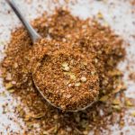 homemade taco seasoning mix on a spoon and marble slab