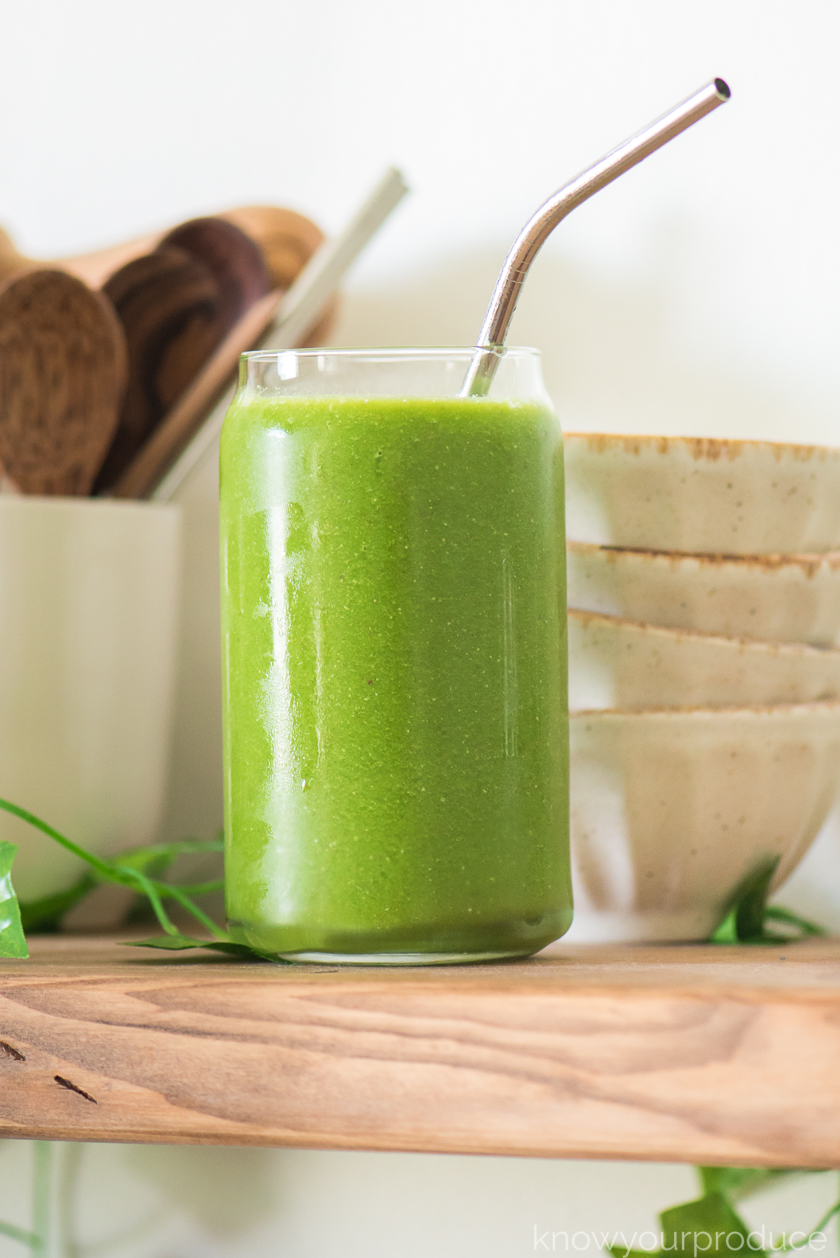 pregnancy smoothie on a wooden shelf with small bowls and cup with wooden spoons in background