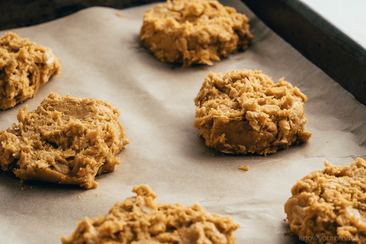 pumpkin oatmeal cookie dough on baking sheet lined with parchment paper