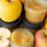 unsweetened applesauce recipe in small mason jars with apples around it