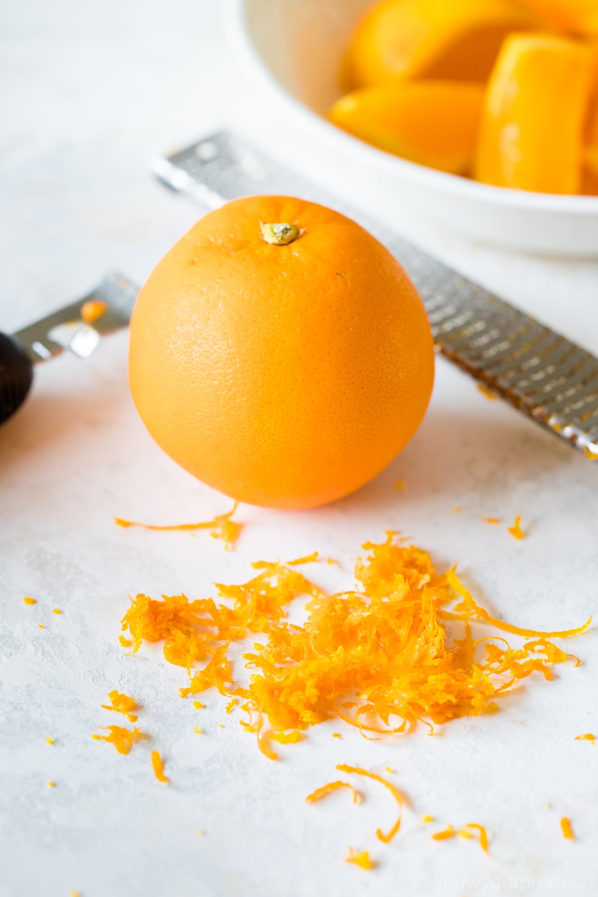 orange zest with an orange behind it