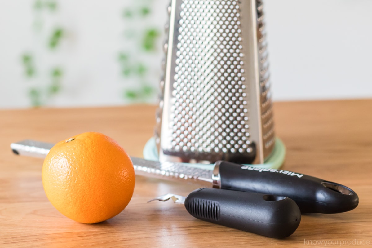 zesting tools with an orange on a table