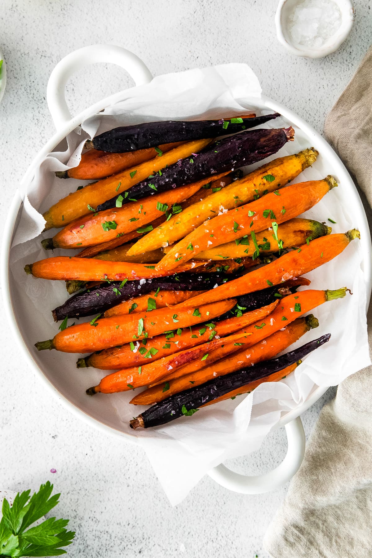 roasted carrots in a white casserole dish with handles