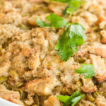stuffing from scratch in a casserole dish with parsley garnish