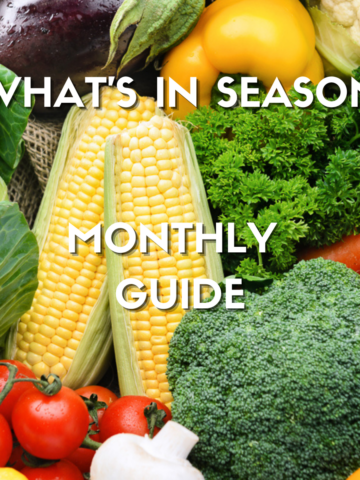 Text on image reading what's in season monthly guide on fresh vegetables overhead photo of corn, broccoli, tomatoes, herbs, eggplant, bell peppers, carrots, and cabbage.