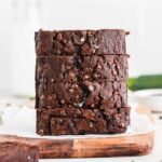 chocolate zucchini bread stacked slices on a cutting board.