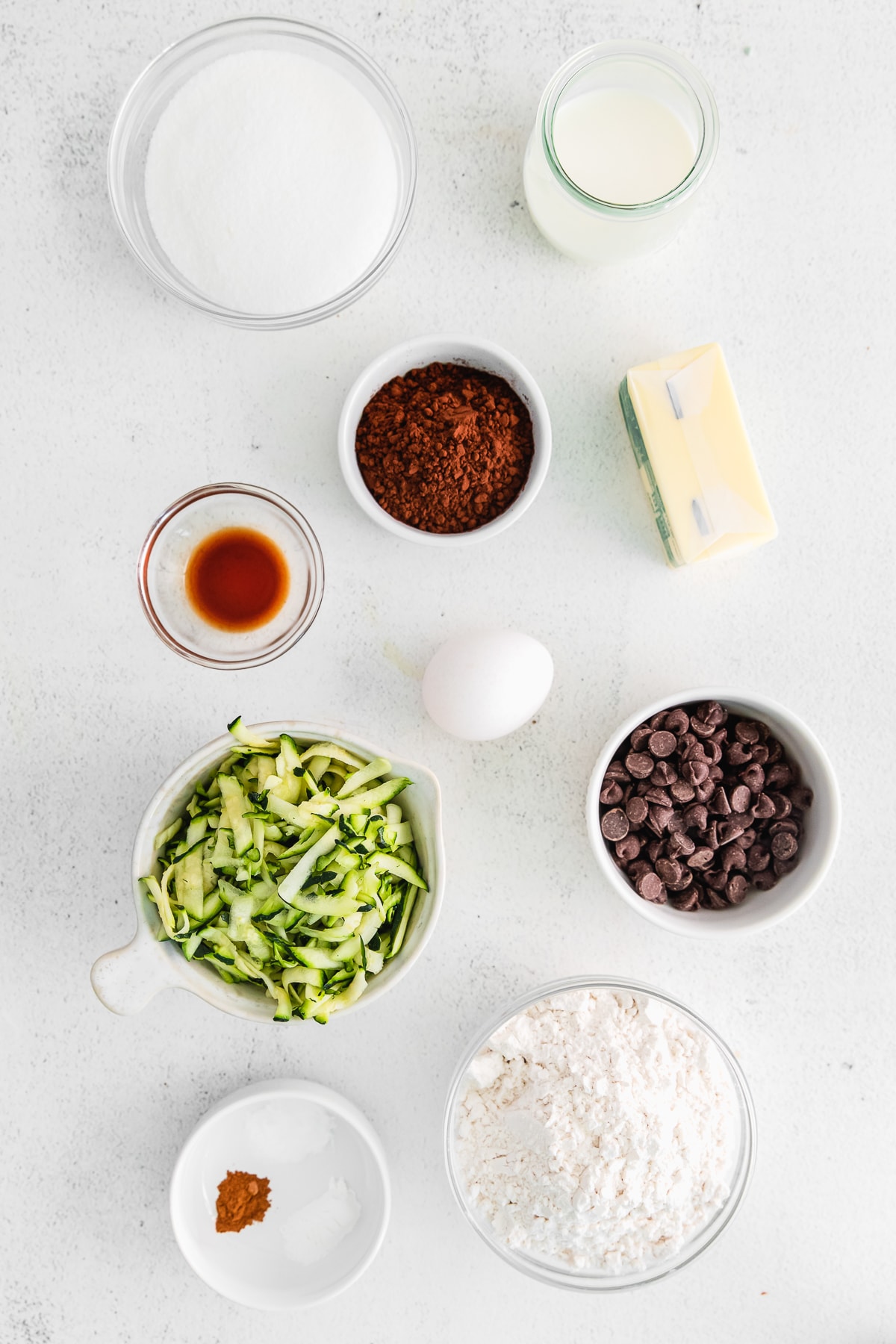 ingredients in small bowls to make double chocolate chip zucchini bread.