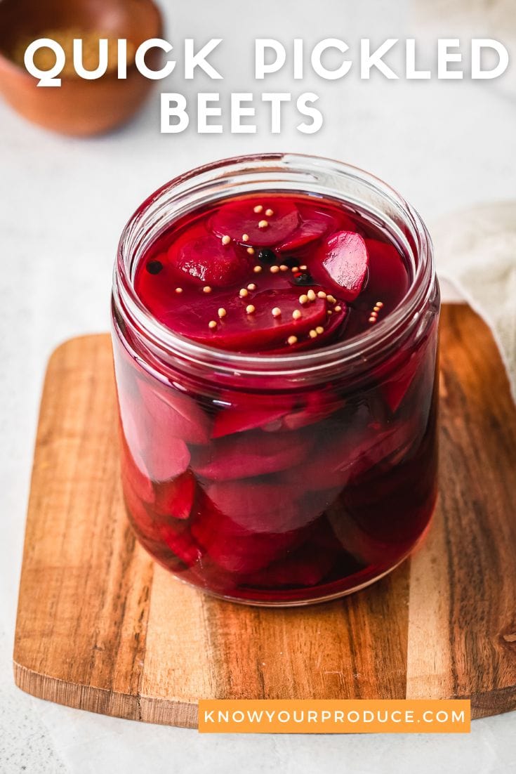 quick pickled beets in a glass jar on a wooden board with text on image for pinterest.