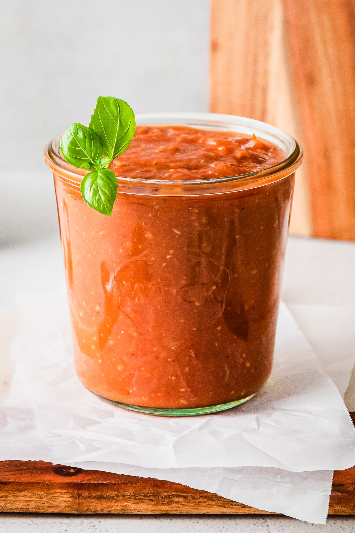 roasted tomato sauce in a glass jar with basil garnish