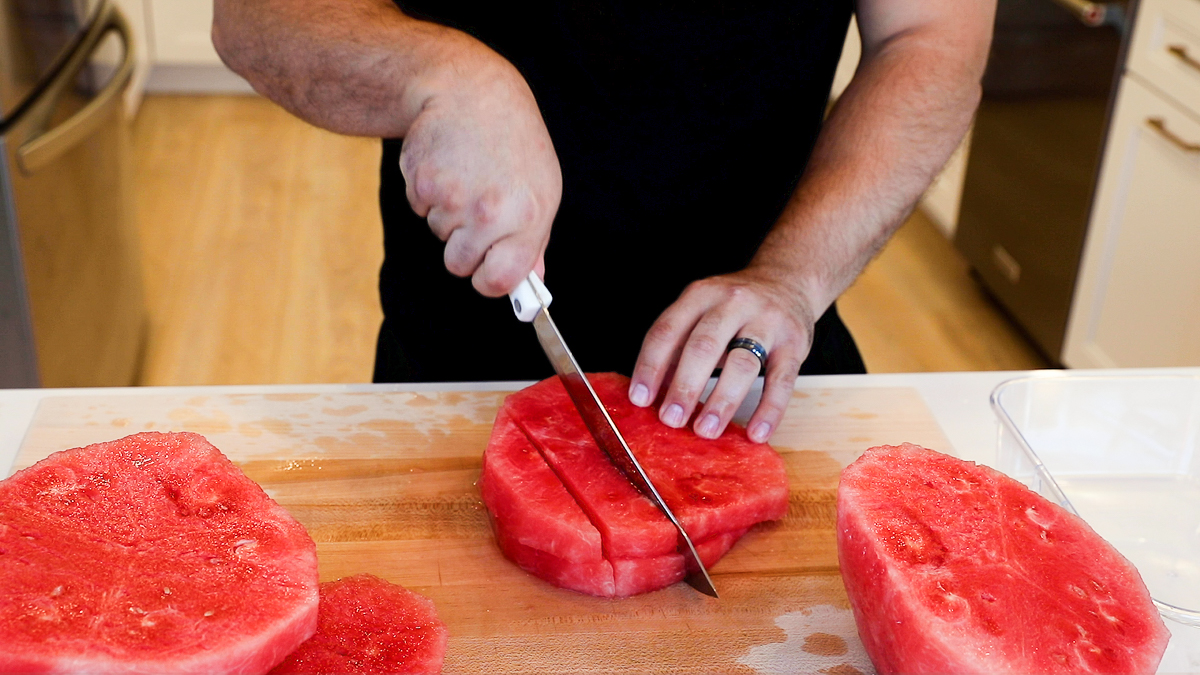 slicing watermelon slices into strips.