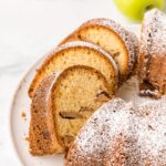 Jewish Apple Cake sliced on a cake plate.
